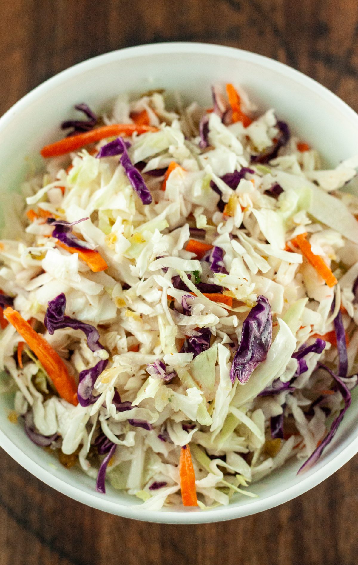 Coleslaw in a bowl dressed with no mayo vinegar coleslaw dressing.