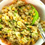 A quinoa salad with corn in a bowl with a fork.