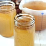 Beef bone broth in the instant pot in jars on the table.