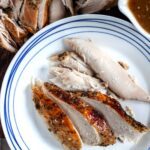Sliced turkey breast in the instant pot on a plate.