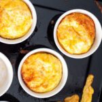 air fryer egg muffins fresh from the air fryer in individual ramekins.