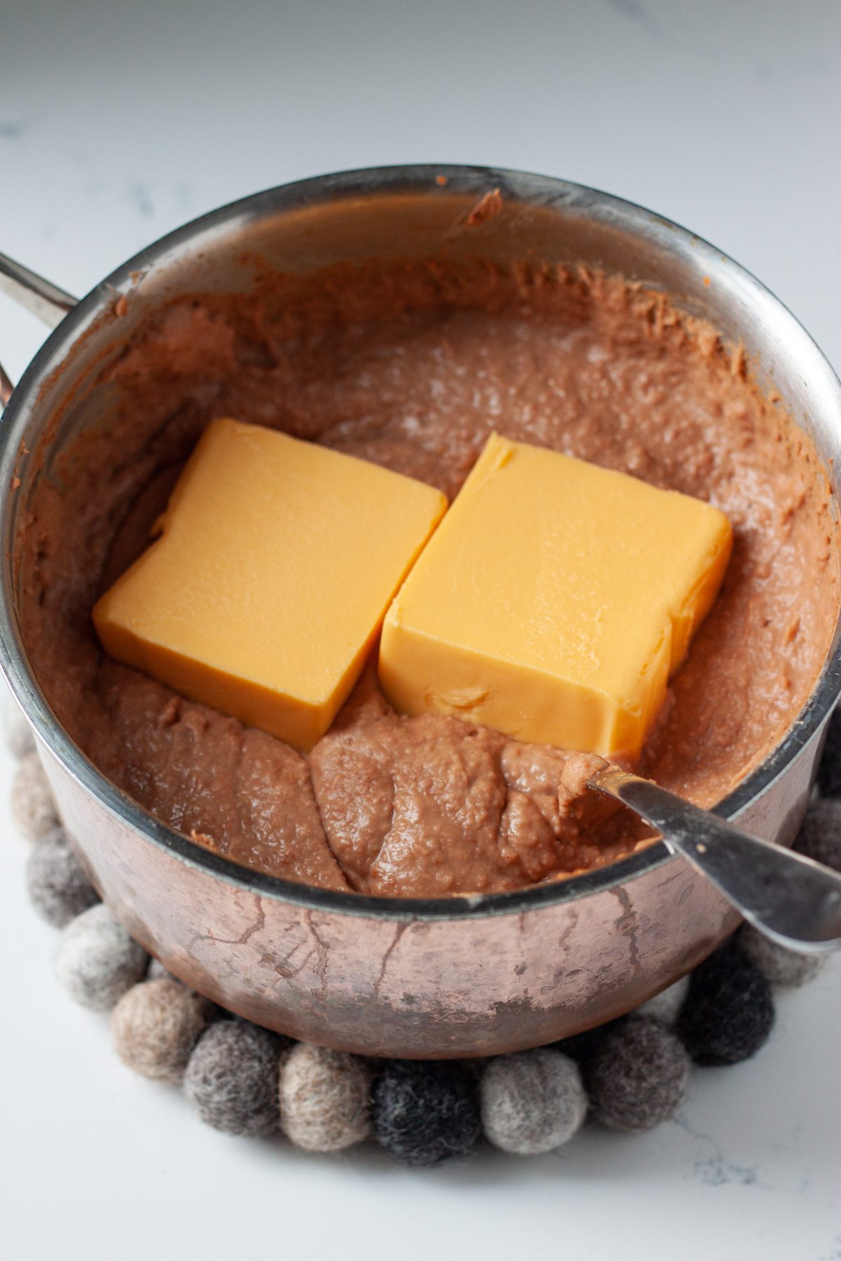 add the velveeta to cheesy refried bean dip