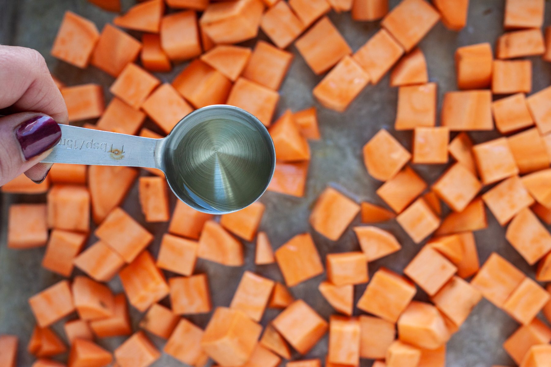 Add olive oil to sweet potatoes