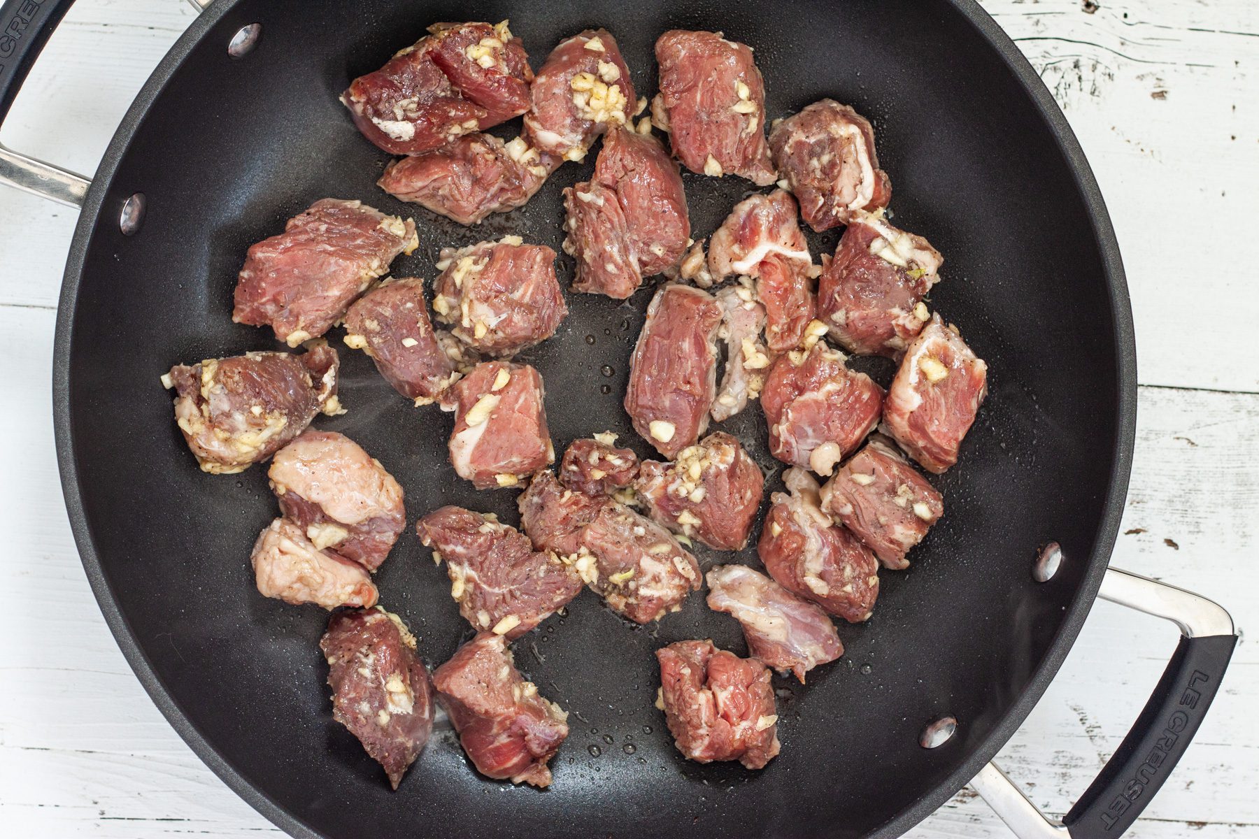 garlic marinaded beef tips in pan