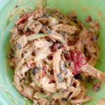 chipotle chicken salad freshly made in a green bowl.