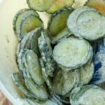 Dill Cucumber Salad freshly stirred in a bowl with a spatula.