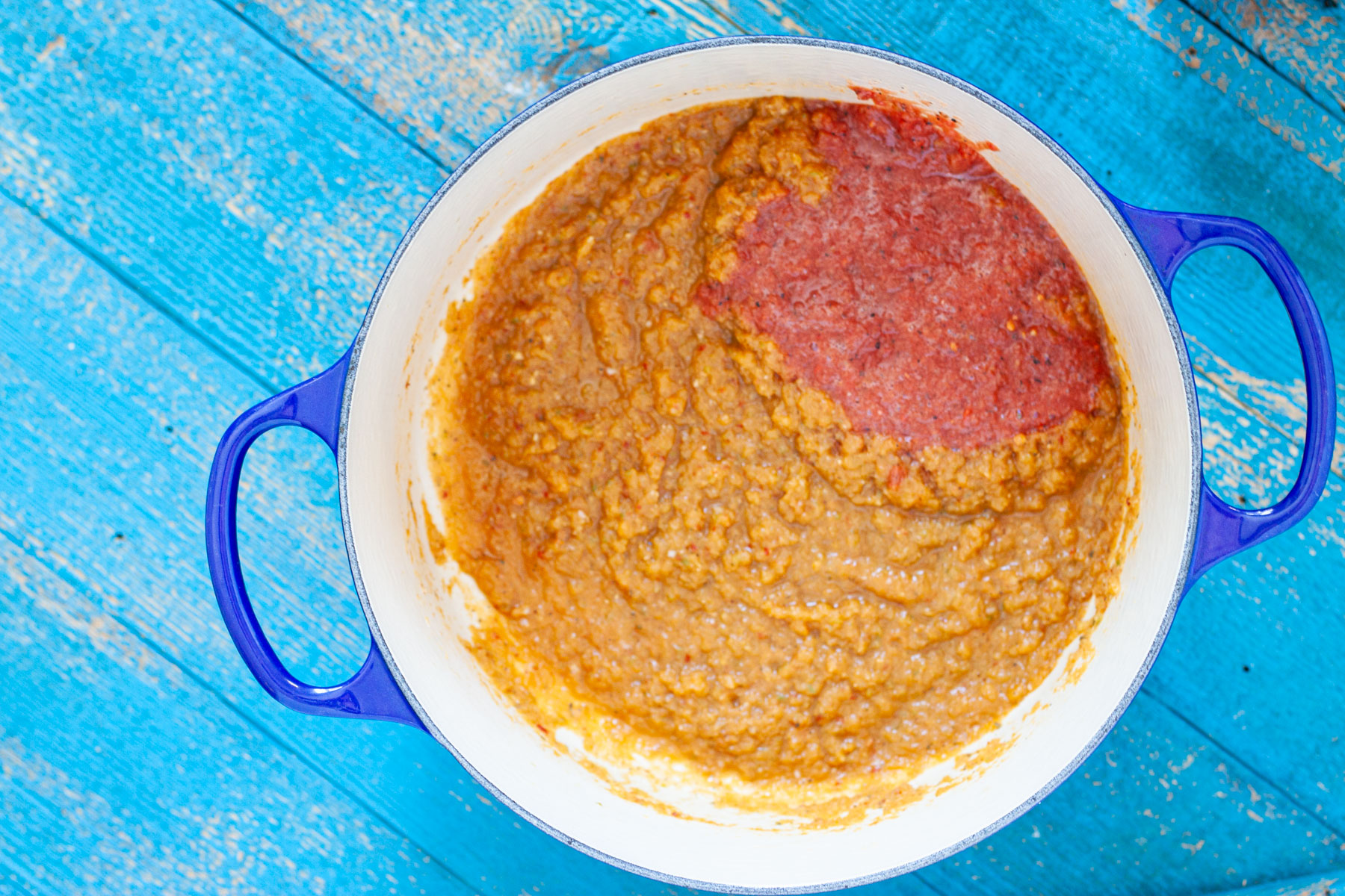 onion, garlic jalapeno, oregano, chipotle en adobo blended into a liquid mix cooking in a Dutch oven with blended Rotel added.