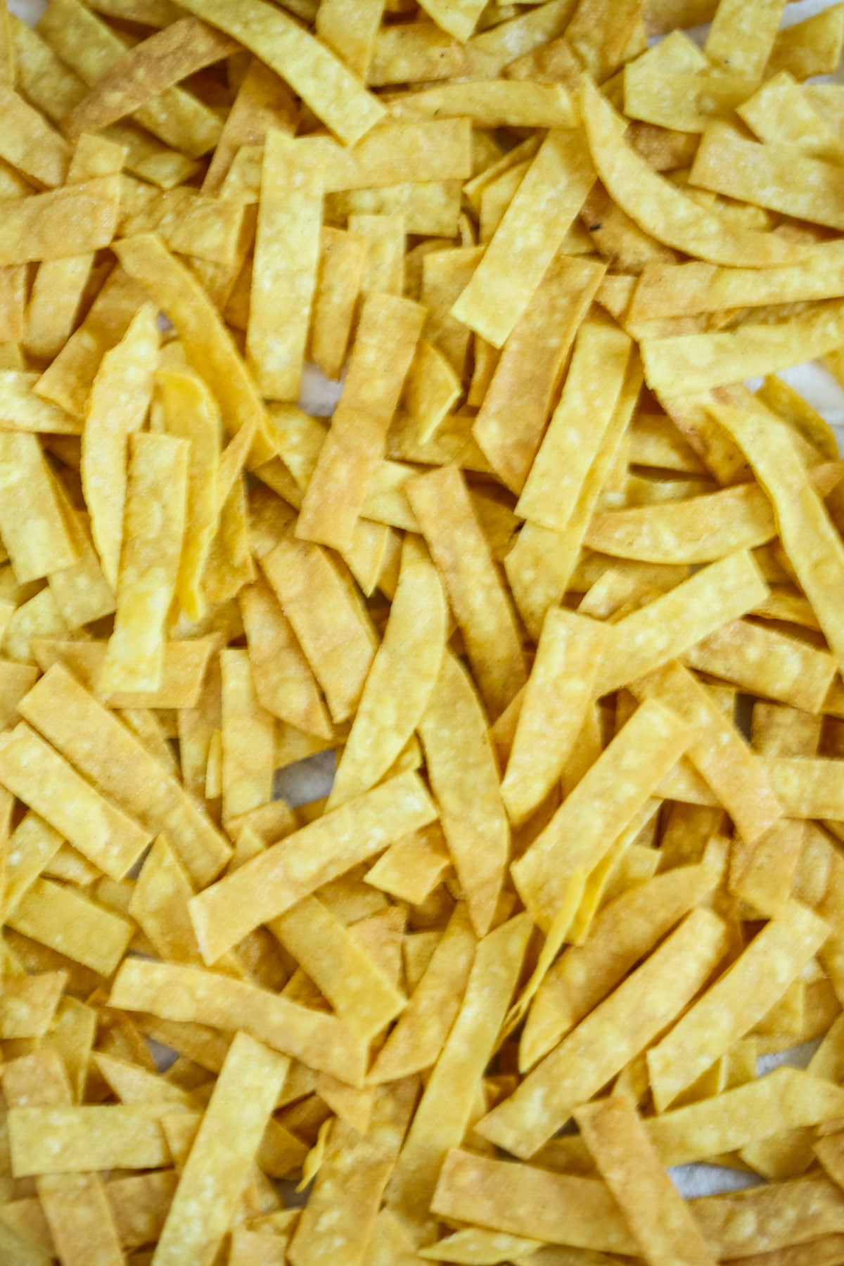 baking sheet full of freshly fried tortilla strips.