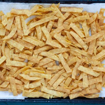 homemade fried tortilla strips resting on paper towels.