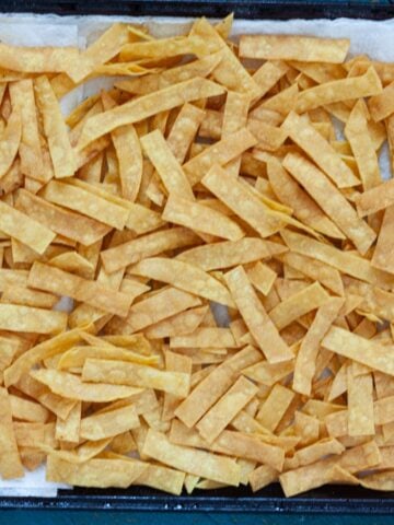 homemade fried tortilla strips resting on paper towels.