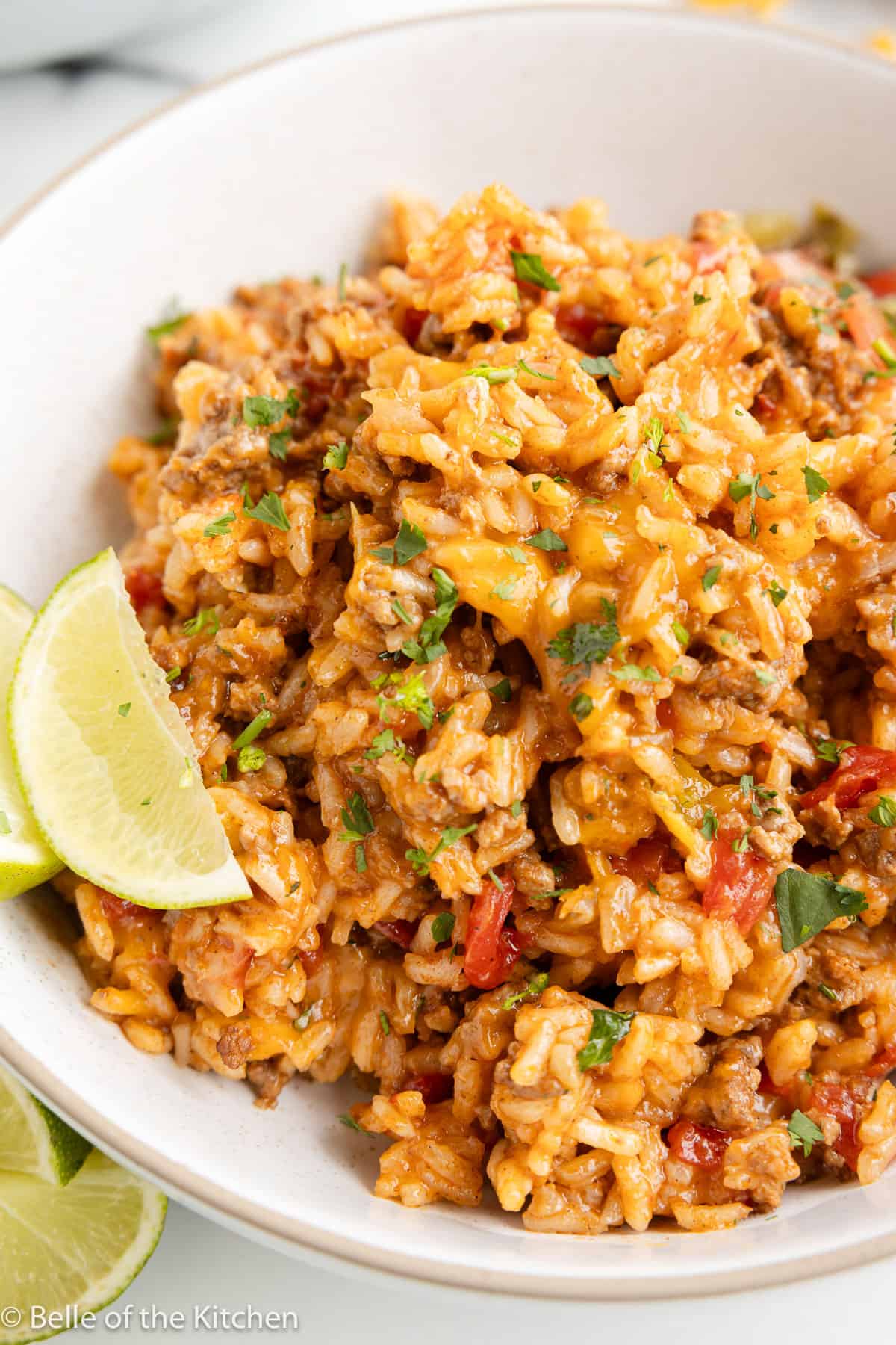 Mexican beef and rice in a bowl served with a lime wedge