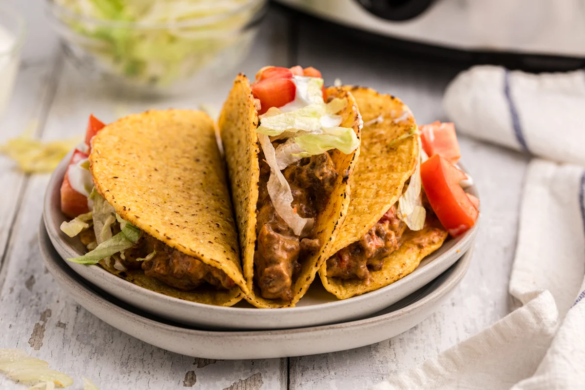 three rotel ground beef tacos sitting on a plate