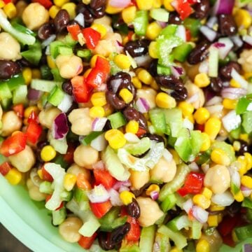 rainbow marinated bean salad in a green bowl.