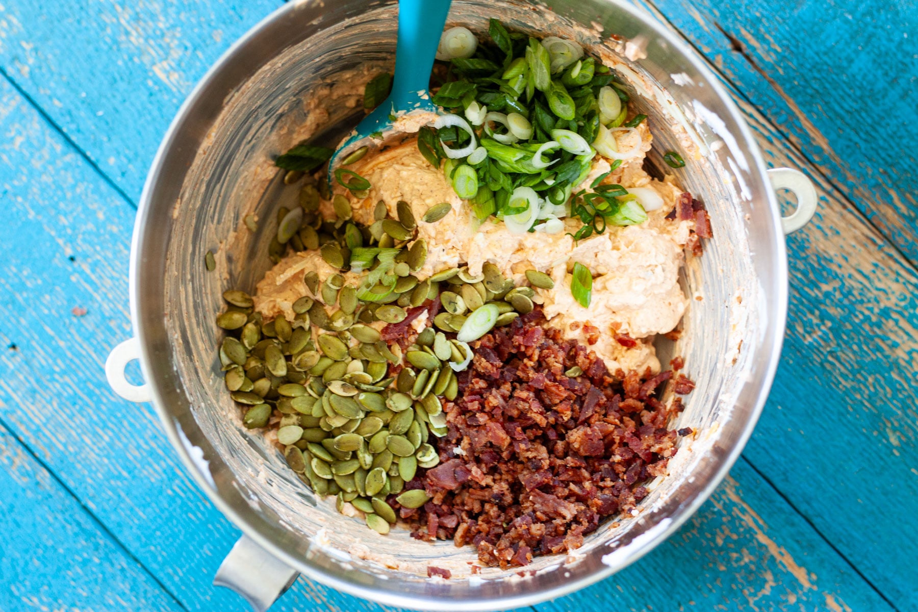 Pepitas, green onion, and bacon bits added to the dip bowl.