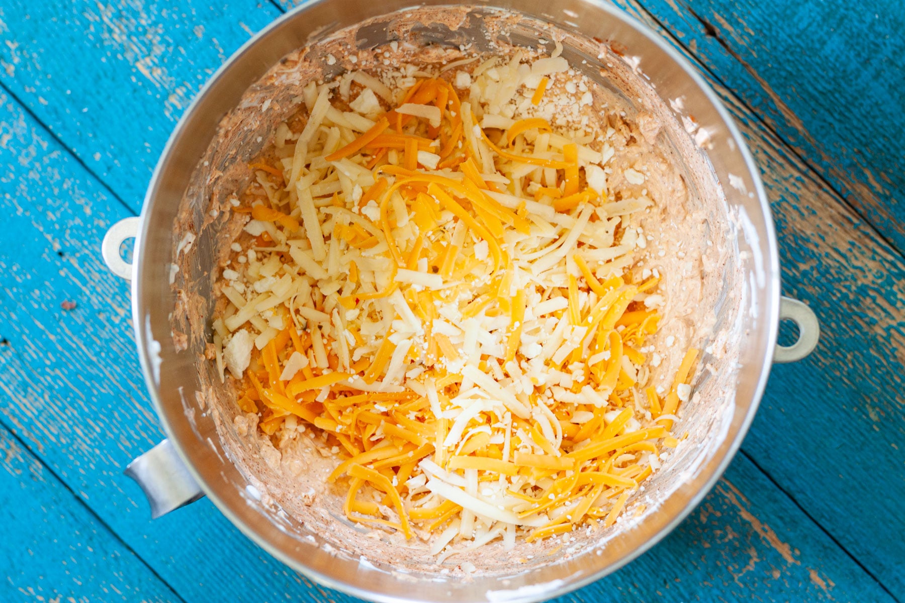 Cheese being added to the million dollar taco dip.