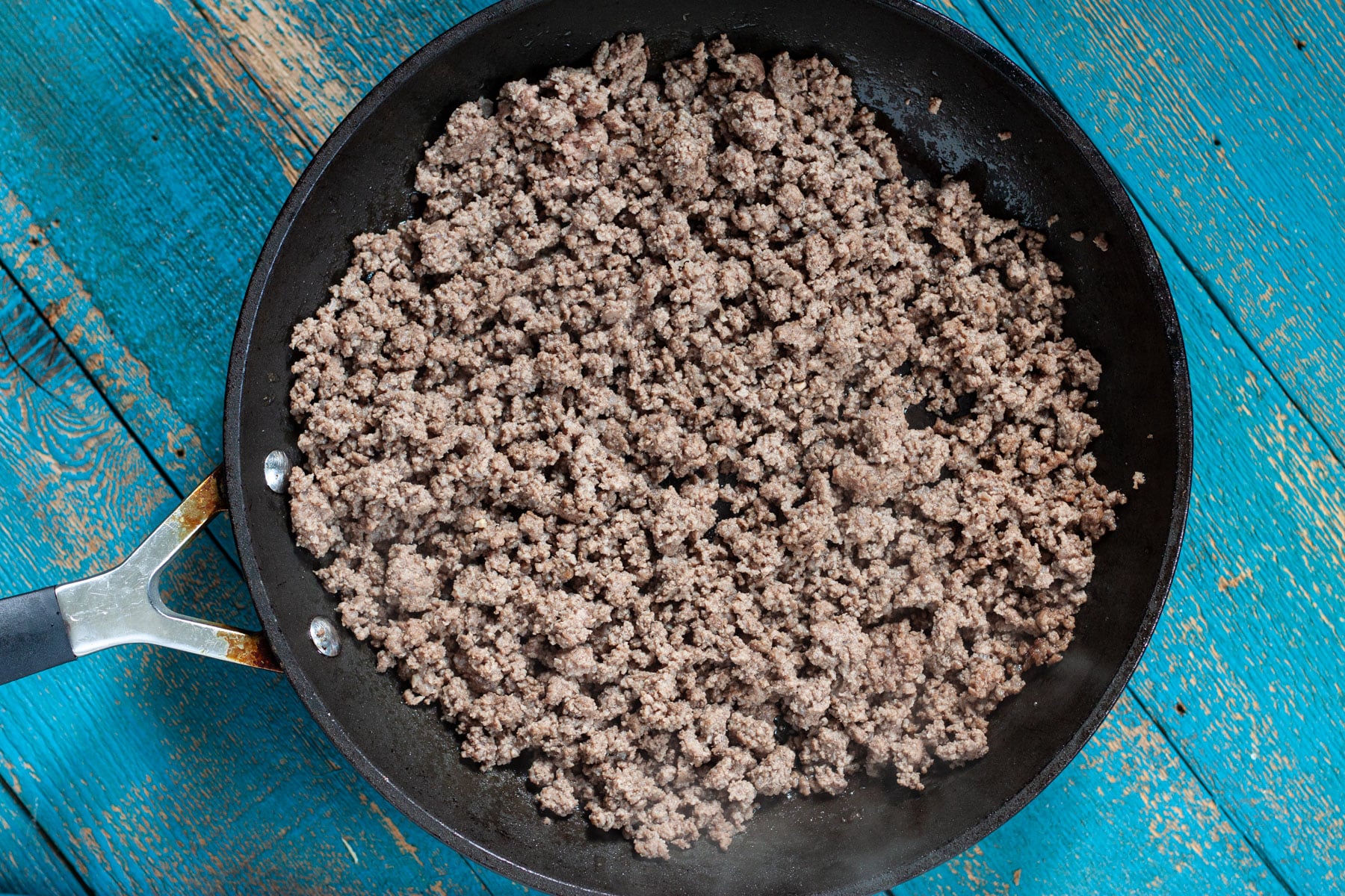 Cooked ground beef in a skillet.